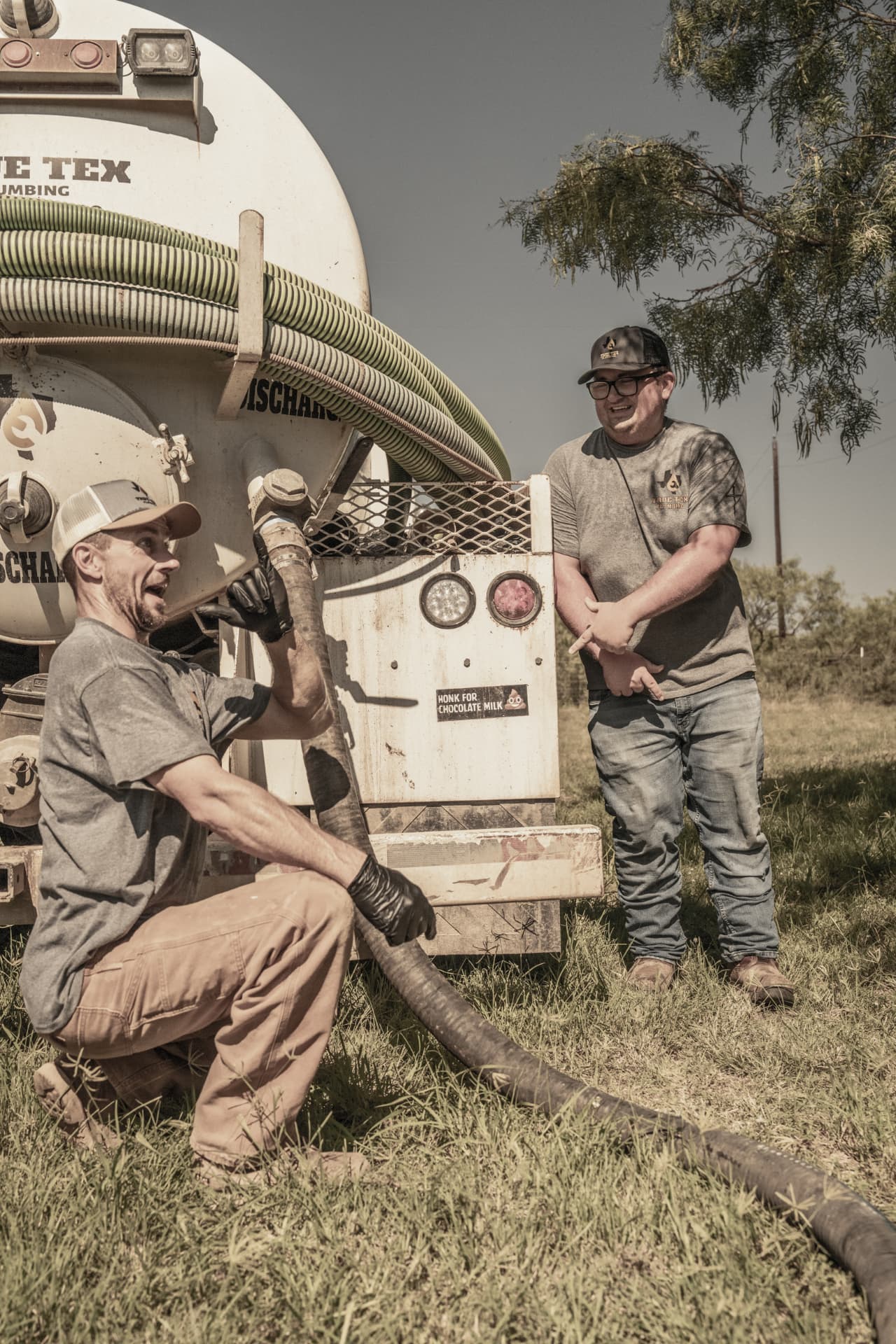 True Tex technicians running hose from the septic pump truck